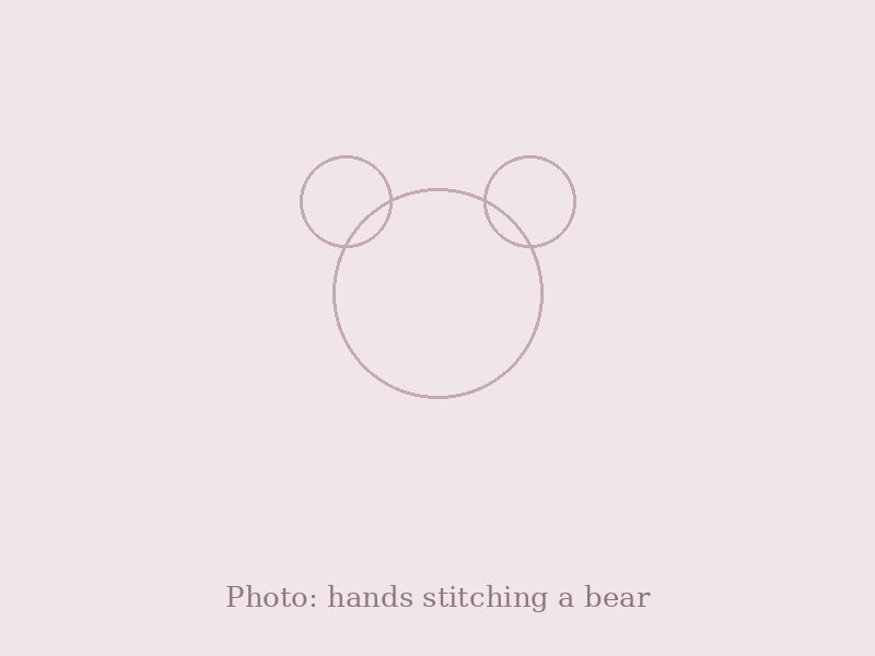 Hands stitching a memory bear, with pieces of fabric nearby